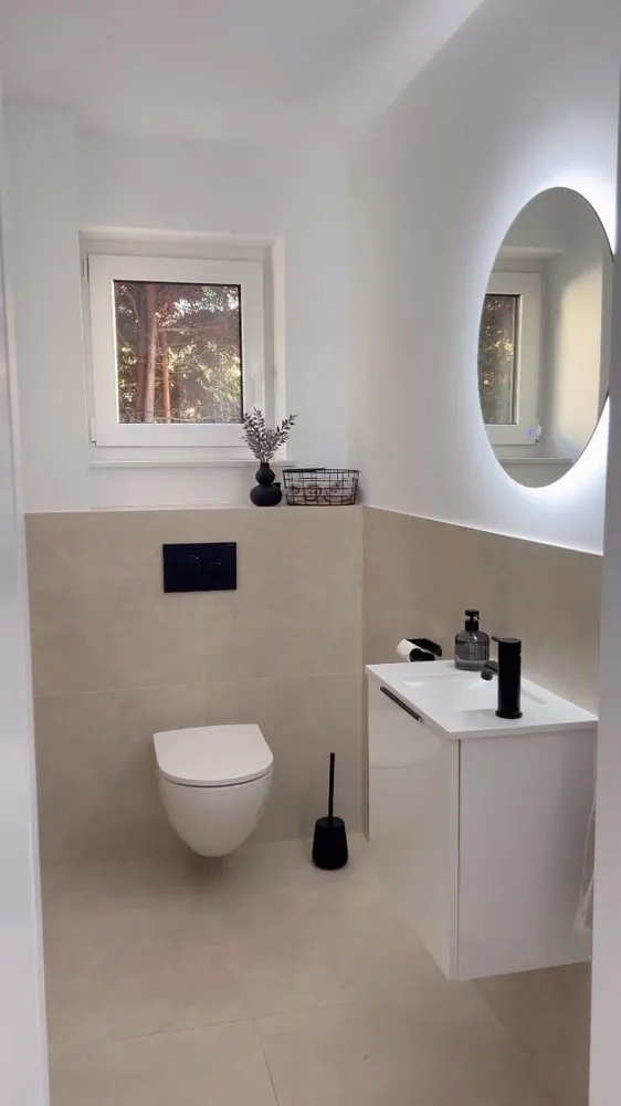 Before: a plain white guest bathroom, photographed on a phone.